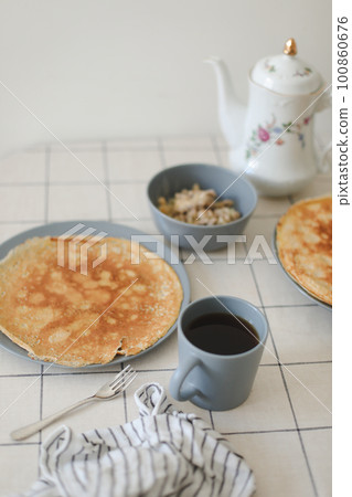Stack of crepes on kitchen table. Pancakes for breakfast, food photography 100860676