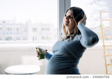 Mental health and wellbeing during pregnancy. Pregnant woman preparing to yoga and meditation exercise at home. Mental health and wellbeing during pregnancy. Pregnant woman preparing to yoga and meditation exercise at home. 100860708