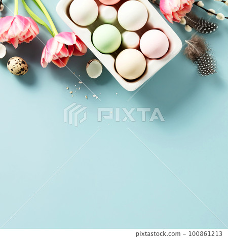 Easter background with spring flowers, eggs and feathers on light blue background top view flat lay copy space 100861213