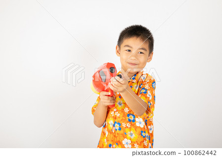 Happy Songkran Day, Asian kid boy with floral shirt hold water gun, Thai child funny hold toy water pistol and smile, isolated on white background, Thailand Songkran festival national culture concept 100862442