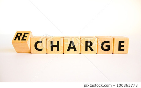 Charge or recharge symbol. Turned wooden cubes and changed the word Charge to Recharge. Beautiful white table white background. Business charge or recharge concept. Copy space. Charge or recharge symbol. Turned wooden cubes and changed the word Charge to Recharge. Beautiful white table white background. Business charge or recharge concept. Copy space. 100863778