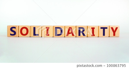 Time to solidarity symbol. Concept word solidarity on wooden cubes on a beautiful white background. White table. Business and solidarity concept. Copy space. Time to solidarity symbol. Concept word solidarity on wooden cubes on a beautiful white background. White table. Business and solidarity concept. Copy space. 100863795