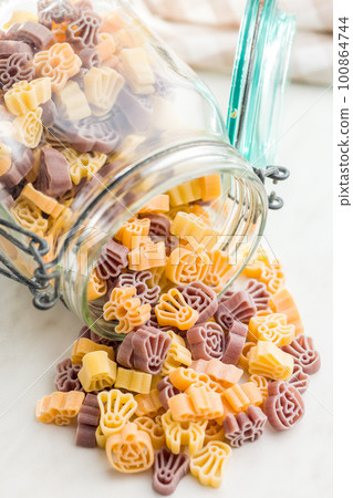 Pasta of various scary shapes. Uncooked halloween pasta in jar. Pasta of various scary shapes. Uncooked halloween pasta in jar. 100864744