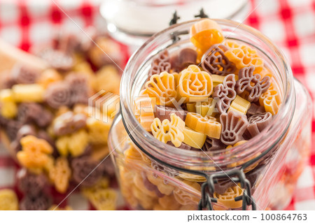 Pasta of various scary shapes. Uncooked halloween pasta in jar. Pasta of various scary shapes. Uncooked halloween pasta in jar. 100864763