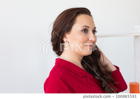 Glamour and beauty, jewelry and luxury concept - close up of beautiful woman face with pearl earring Glamour and beauty, jewelry and luxury concept - close up of beautiful woman face with pearl earring 100865591