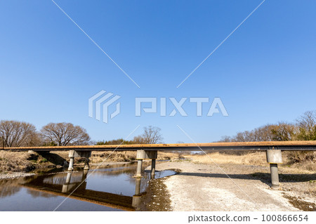 wooden bridge under the blue sky 100866654