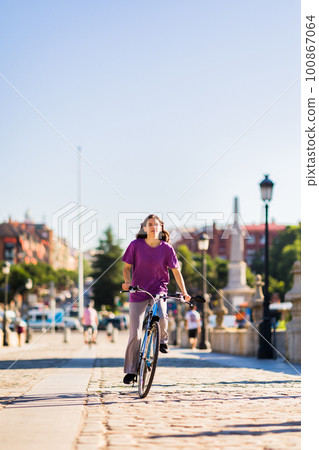 sustainability eco transport lifestyle. uruguayan mid latina woman ride a bike outside in the city sustainability eco transport lifestyle. uruguayan mid latina woman ride a bike outside in the city 100867064