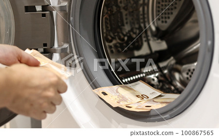 Euro money banknotes in washing machine - illegal cash 50 and mafia money laundering - tax evasion in Europe inflation and impairment. money laundering concept - euro banknotes in washing mashine Euro money banknotes in washing machine - illegal cash 50 and mafia money laundering - tax evasion in Europe inflation and impairment. money laundering concept - euro banknotes in washing mashine 100867565