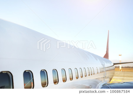 Airplane being preparing ready for takeoff in international airport at sunset - Travel around the world. High quality photo Airplane being preparing ready for takeoff in international airport at sunset - Travel around the world. High quality photo 100867584