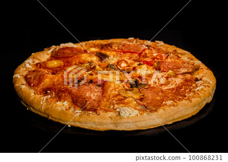 Burnt homemade pizza on tray in electric oven, black background Burnt homemade pizza on tray in electric oven, black background 100868231