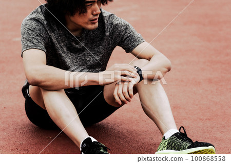 Male runner checking smart watch Male runner checking smart watch 100868558