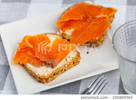 Two sandwiches with white bread butter and smoked salmon Two sandwiches with white bread butter and smoked salmon 100869363
