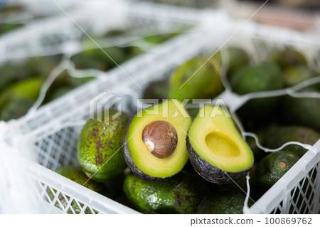 Fresh ripe sliced avocado on boxes close up Fresh ripe sliced avocado on boxes close up 100869762
