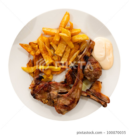 Baked lamb ribs with french fries and aioli sauce Baked lamb ribs with french fries and aioli sauce 100870035