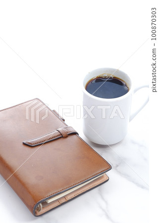Brown leather notebook and black coffee Brown leather notebook and black coffee 100870303