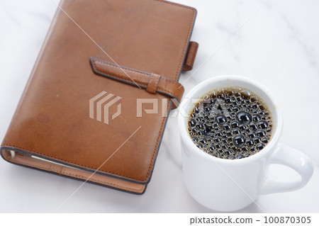 Brown leather notebook and black coffee Brown leather notebook and black coffee 100870305