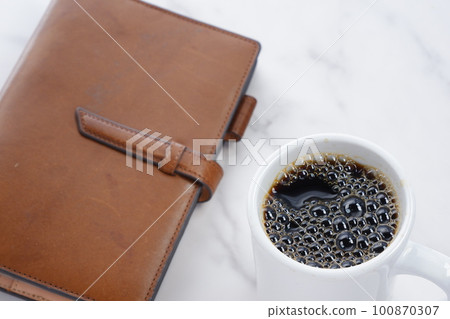 Brown leather notebook and black coffee Brown leather notebook and black coffee 100870307