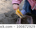 Toddler playing with sand 100872929