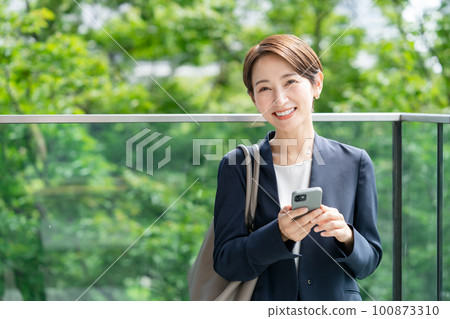 Business woman with a smartphone Business woman with a smartphone 100873310
