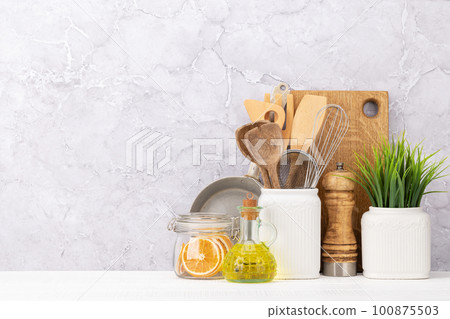 Kitchen utensils on wooden table Kitchen utensils on wooden table 100875503