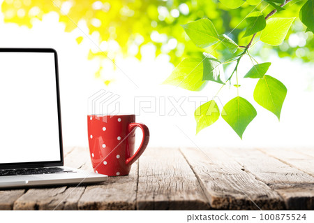 Laptop and coffee cup Laptop and coffee cup 100875524