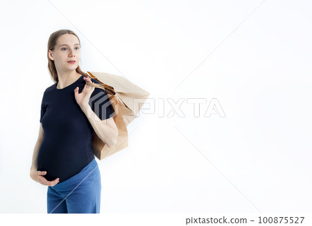 smiling beautiful young pregnant woman holding paper bags 100875527