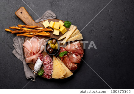 Antipasto board with various meat and cheese snacks 100875565