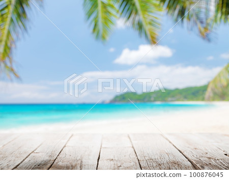 Empty wooden table or pier with sunny beach and sea Empty wooden table or pier with sunny beach and sea 100876045