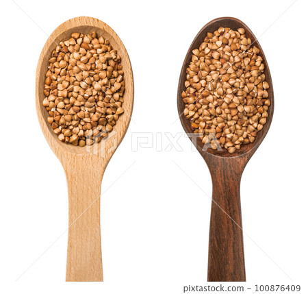Two wooden spoons with buckwheat isolated on white background. Light and dark wood. Top view 100876409