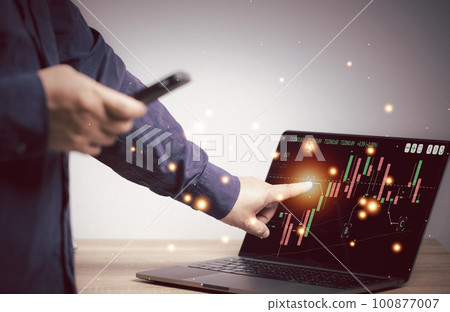 Businessman checking data from mobile phone, Point at the computer screen to place orders for stocks or cryptocurrencies online. stock trading ideas. Cryptocurrencies, Finance, Banking, Industry. 100877007