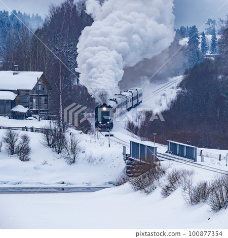 Retro steam train moves at winter morning time. Retro steam train moves at winter morning time. 100877354