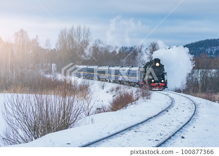 Retro steam train moves at winter morning time. Retro steam train moves at winter morning time. 100877366