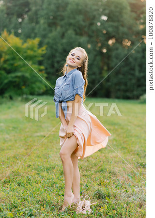 Happy Caucasian young woman, girl walking in the summer outdoors in nature 100878820