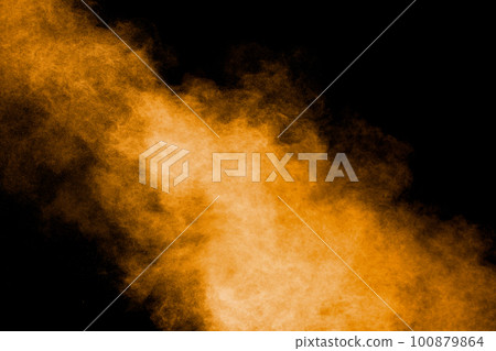 Abstract explosion of orange dust on black background.Freeze motion of orange powder burst. 100879864