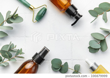 Spa treatment concept. natural spa cosmetics products with eucalyptus oil, massage jade roller, eucalyptus leaf. 100879999