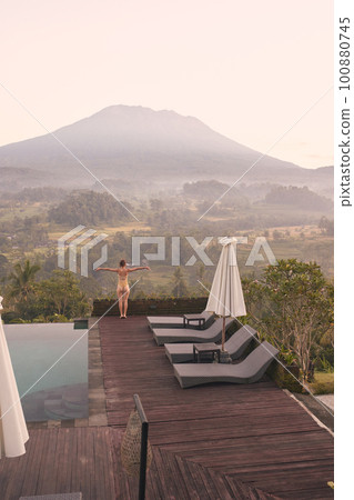 Beautiful Woman Enjoying Pool in Mountains. Young Woman In Swimsuit Resting 100880745