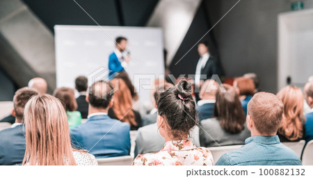 Pitch presentation and project discussion at business convention or team meeting. Audience at the conference hall. Business and entrepreneurship symposium 100882132