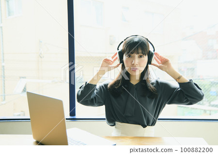 Young woman using a laptop in the office Young woman using a laptop in the office 100882200