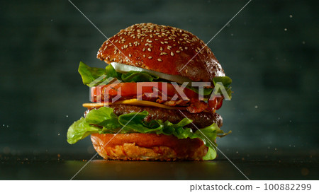 Tasty beef burger on black stone table, close-up 100882299