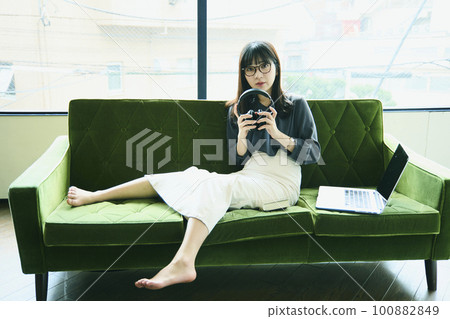 Woman relaxing on the sofa Portrait 100882849