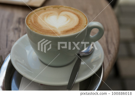 hot coffee on a wooden table hot coffee on a wooden table 100886018