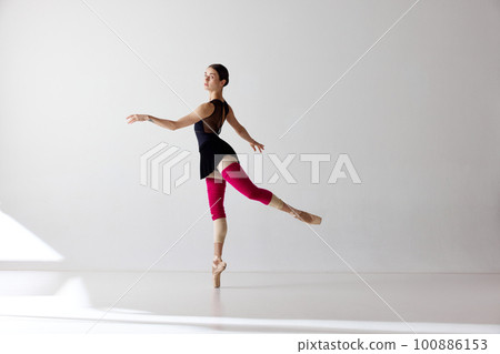 Young classical dancer dancing on fingertips over white background Young classical dancer dancing on fingertips over white background 100886153