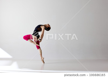 Young and graceful ballet dancer isolated over white background. Flexible ballerina, weightless jumps Young and graceful ballet dancer isolated over white background. Flexible ballerina, weightless jumps 100886165
