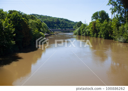 a small river in a forest 100886262