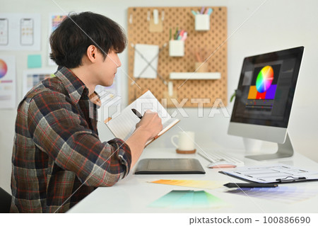 Young hipster man sketch planning application process development prototype wireframe for web mobile phone at office Young hipster man sketch planning application process development prototype wireframe for web mobile phone at office 100886690