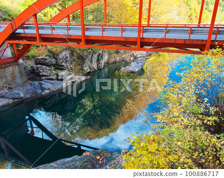 Mt. Mitake, Kiso Town, autumnal trees surrounding the Tokiwa Bridge over the Otaki River Mt. Mitake, Kiso Town, autumnal trees surrounding the Tokiwa Bridge over the Otaki River 100886717
