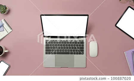 Top view of laptop computer, digital tablet and smart phone on pink background. Blank screen for advertise design 100887020