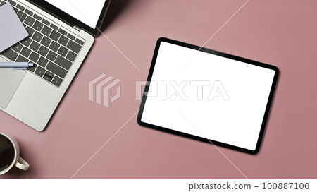 Digital tablet, laptop, coffee cup and sticky notes on pink background. Blank screen for text information or content Digital tablet, laptop, coffee cup and sticky notes on pink background. Blank screen for text information or content 100887100