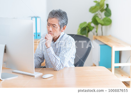 Senior man using a computer Senior man using a computer Senior man using a computer Senior man using a computer 100887655