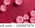 Trendy color of the year 2023. Bright creative background. Natural flowers and wave water on shining background toned in viva magenta color. Flat lay Top view 100887876